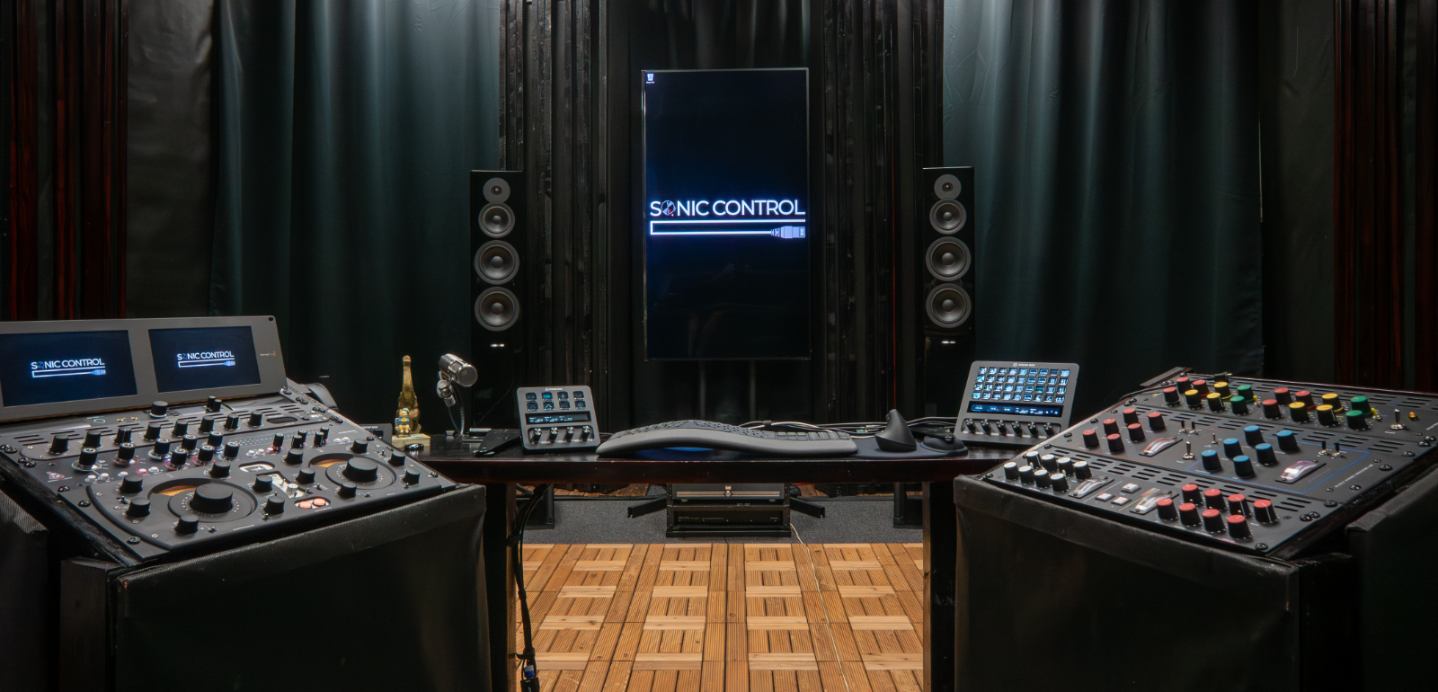 Sonic Control mastering studio — wide room shot with mastering consoles, monitors, and the Sonic Control logo on the center display